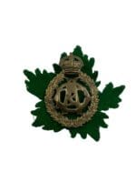 WW2 Canadian Army Dental Corps Cap Badge with Green Maple Leaf Backing